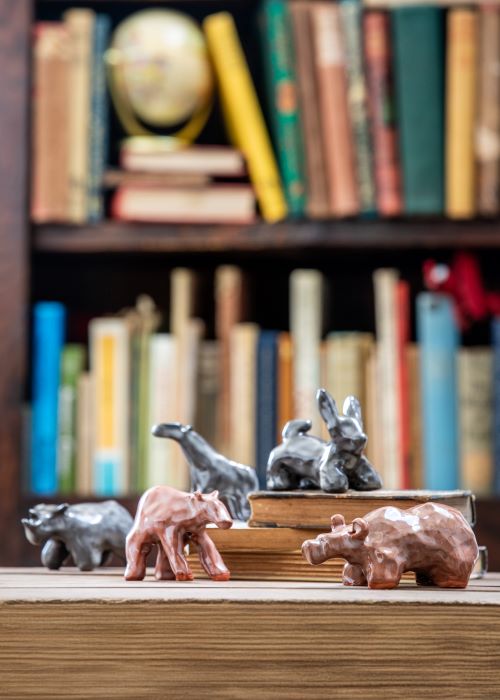 Ceramic creatures in front of collection