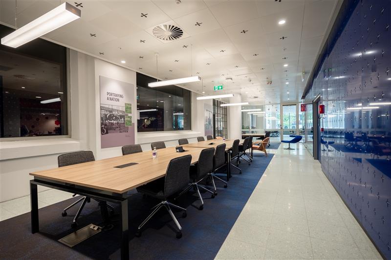 A long conference room with a table and chairs