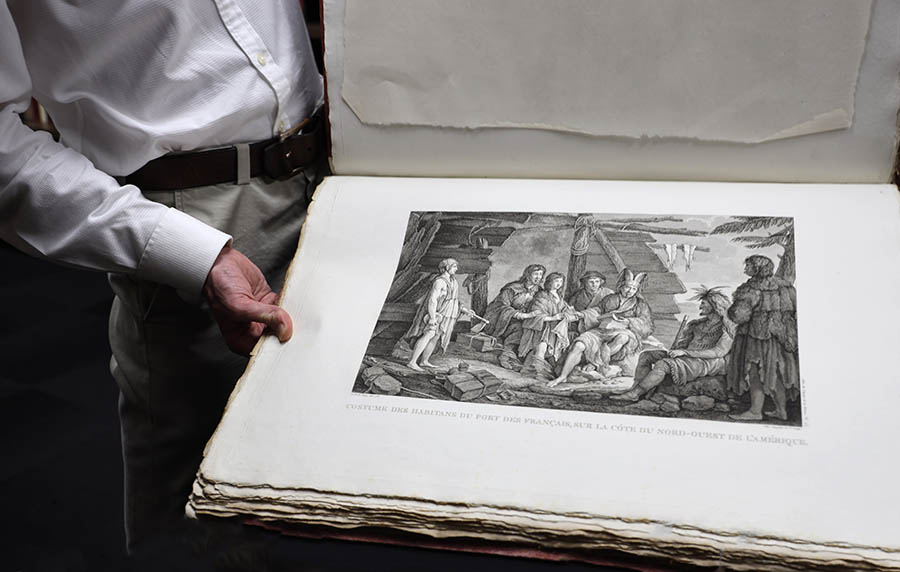 Man holding large illustrated book