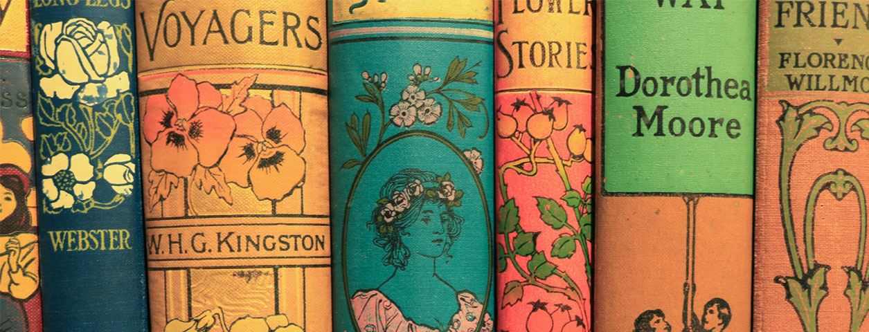 Colourful spines of vintage children’s books from our children's historical collection, featuring floral and illustrated designs.